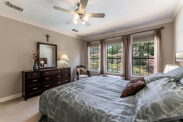 17718 Dove Tree Ln, Spring, TX 77379 - bedroom with light colored carpet, multiple windows, baseboards, a textured ceiling, and crown molding