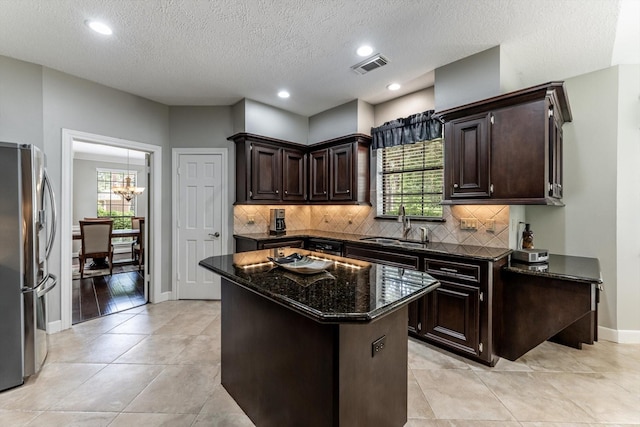 17718 Dove Tree Ln, Spring, TX 77379 - kitchen with stainless steel refrigerator with ice dispenser, a sink, healthy amount of natural light, dark brown cabinetry, and recessed lighting