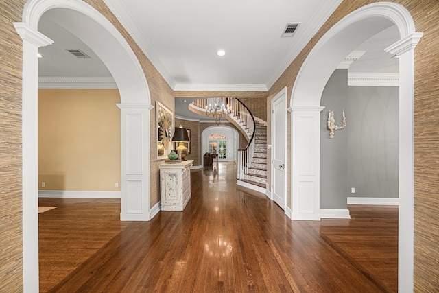 5567 Longmont Dr, Houston, TX 77056 - entrance foyer featuring arched walkways, wood finished floors, stairs, baseboards, and ornamental molding