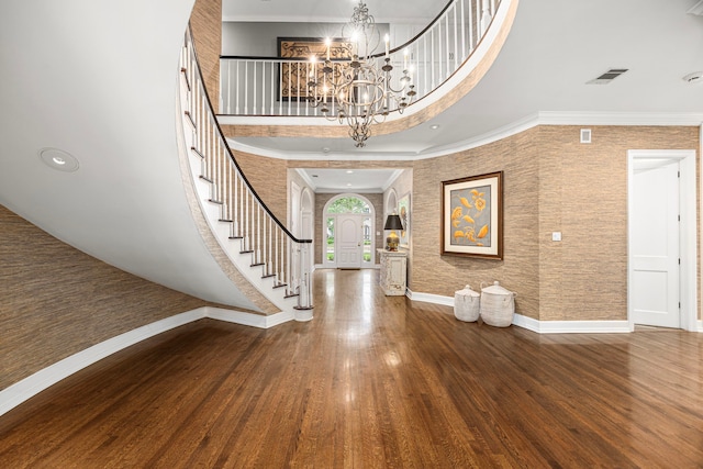 5567 Longmont Dr, Houston, TX 77056 - entrance foyer featuring a towering ceiling, a chandelier, stairway, wood finished floors, and crown molding