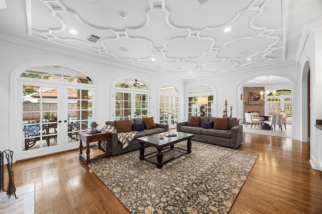 5567 Longmont Dr, Houston, TX 77056 - living area featuring arched walkways, healthy amount of natural light, crown molding, french doors, and wood finished floors