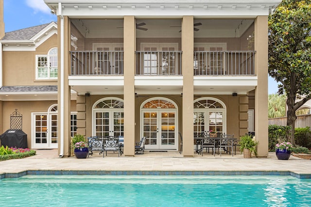 5567 Longmont Dr, Houston, TX 77056 - rear view of property with french doors, a balcony, and an outdoor pool