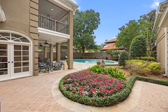 5567 Longmont Dr, Houston, TX 77056 - view of swimming pool with french doors, ceiling fan, a patio area, and a fenced backyard