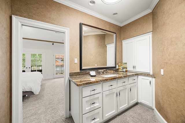5567 Longmont Dr, Houston, TX 77056 - bathroom with ornamental molding, a textured wall, vanity, and baseboards
