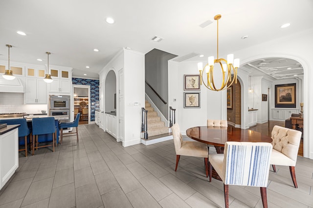 5567 Longmont Dr, Houston, TX 77056 - dining area featuring crown molding, a chandelier, arched walkways, recessed lighting, and stairs