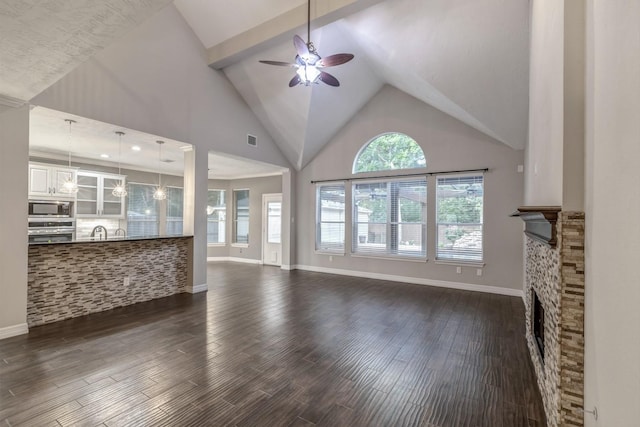 4531 Mulberry Park Ln, Houston, TX 77345 - unfurnished living room featuring ceiling fan, baseboards, dark wood-style flooring, and high vaulted ceiling