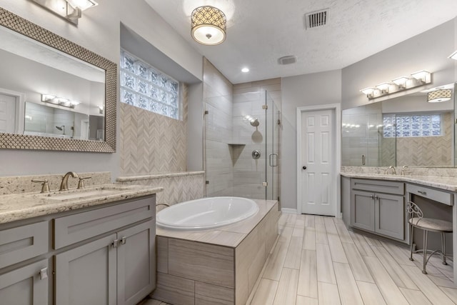 4531 Mulberry Park Ln, Houston, TX 77345 - full bathroom with a shower stall, a bath, and two vanities