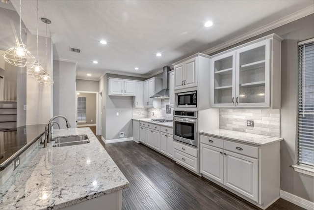4531 Mulberry Park Ln, Houston, TX 77345 - kitchen featuring stainless steel appliances, wall chimney range hood, a sink, baseboards, and ornamental molding