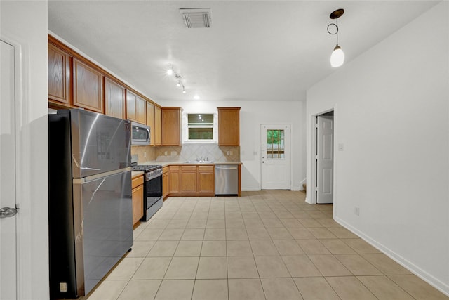 10239 W Palm Lake Dr, Houston, TX 77034 - kitchen featuring appliances with stainless steel finishes, backsplash, light tile patterned floors, light countertops, and decorative light fixtures