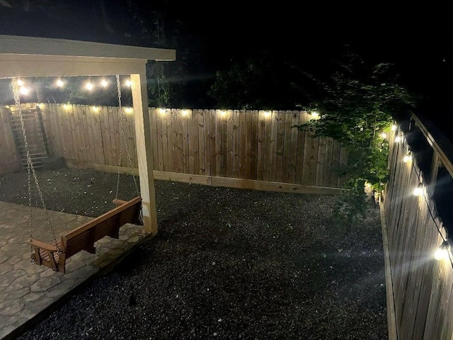 10239 W Palm Lake Dr, Houston, TX 77034 - yard at night featuring a fenced backyard