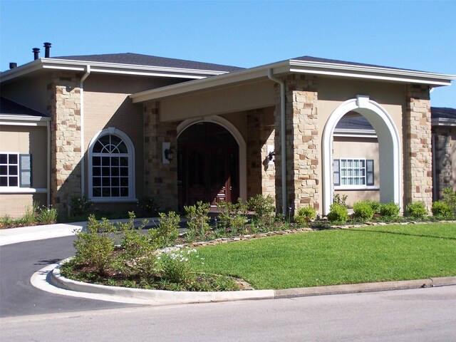 1967 Greentree Dr, Huntsville, TX 77340 - view of front of property featuring a front yard and stone siding