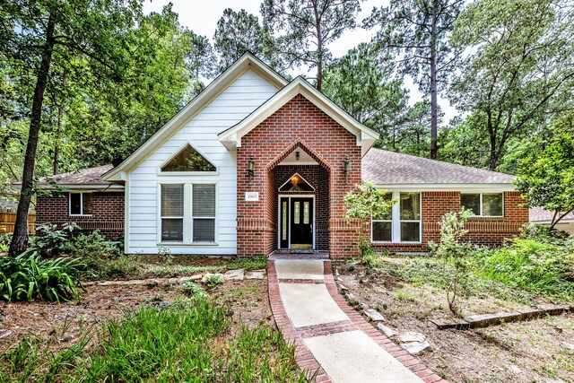 1967 Greentree Dr, Huntsville, TX 77340 - view of front of house with brick siding and a shingled roof