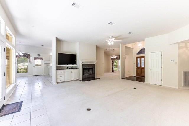 1967 Greentree Dr, Huntsville, TX 77340 - unfurnished living room featuring a high end fireplace, a ceiling fan, healthy amount of natural light, and a chandelier