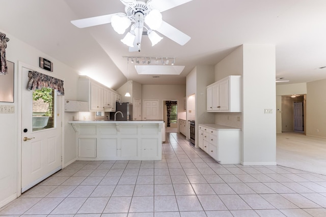 1967 Greentree Dr, Huntsville, TX 77340 - kitchen featuring freestanding refrigerator, a peninsula, light countertops, ceiling fan, and lofted ceiling