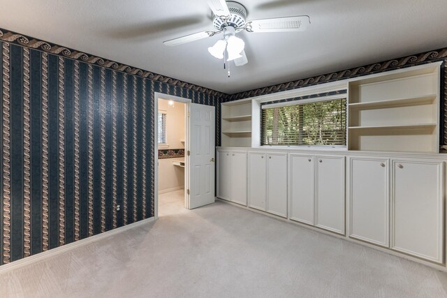 1967 Greentree Dr, Huntsville, TX 77340 - unfurnished bedroom with light carpet, a ceiling fan, connected bathroom, and baseboards