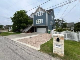 1205 Hall Ave, Seabrook, TX 77586 - raised beach house with driveway and a garage