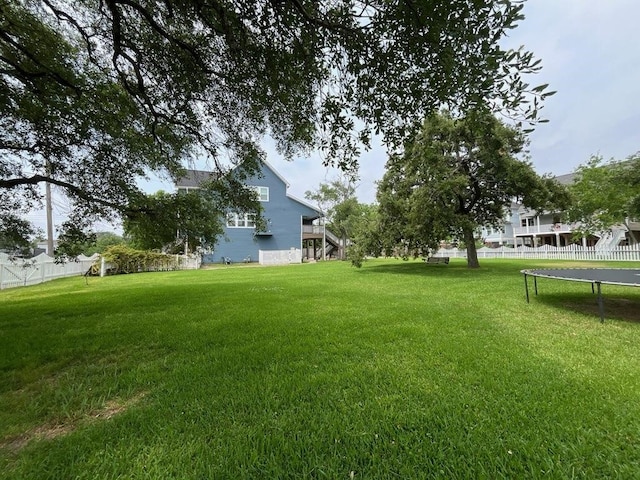 1205 Hall Ave, Seabrook, TX 77586 - view of yard featuring a trampoline