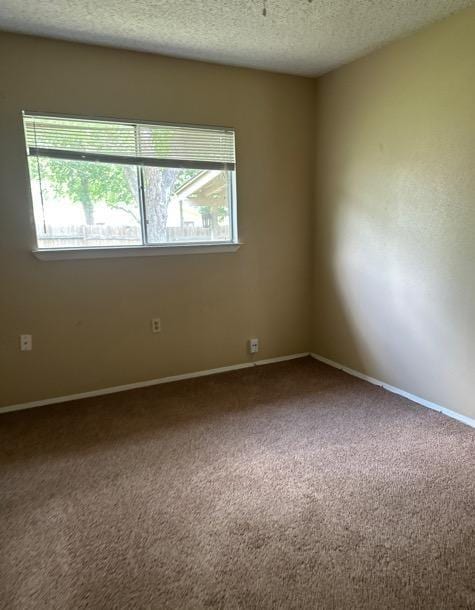 4735 El Vedado St, San Antonio, TX 78233 - carpeted spare room with a textured ceiling and baseboards