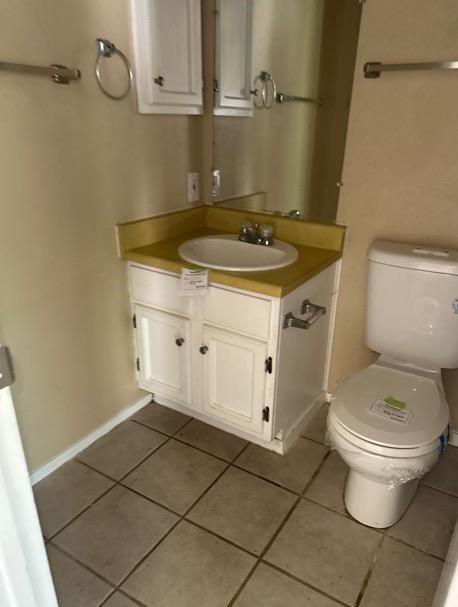 4735 El Vedado St, San Antonio, TX 78233 - bathroom featuring tile patterned flooring, toilet, vanity, and baseboards