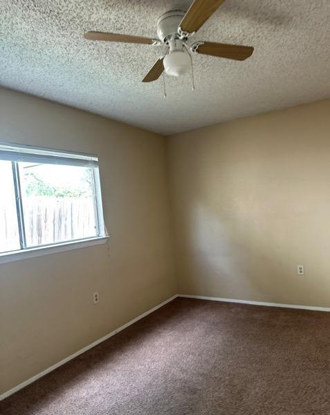 4735 El Vedado St, San Antonio, TX 78233 - carpeted spare room featuring a textured ceiling, a ceiling fan, and baseboards