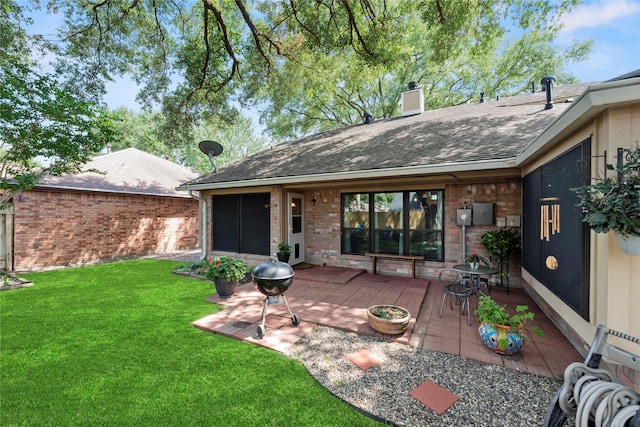 16310 Leamington Ln, Houston, TX 77095 - rear view of property featuring a lawn, a chimney, brick siding, a shingled roof, and a patio area