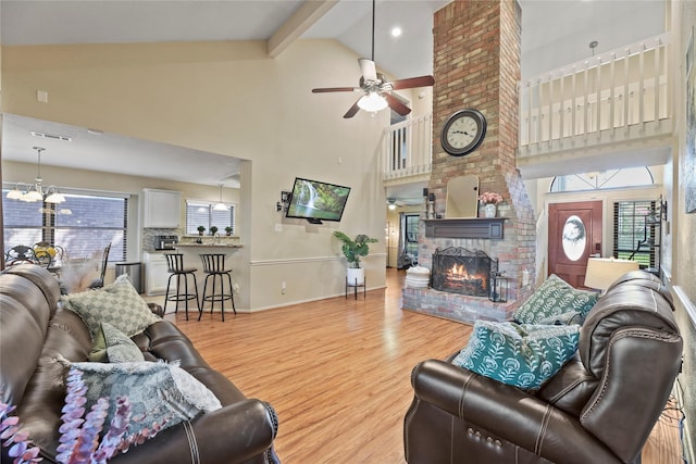 16310 Leamington Ln, Houston, TX 77095 - living area with high vaulted ceiling, ceiling fan, wood finished floors, a fireplace, and plenty of natural light