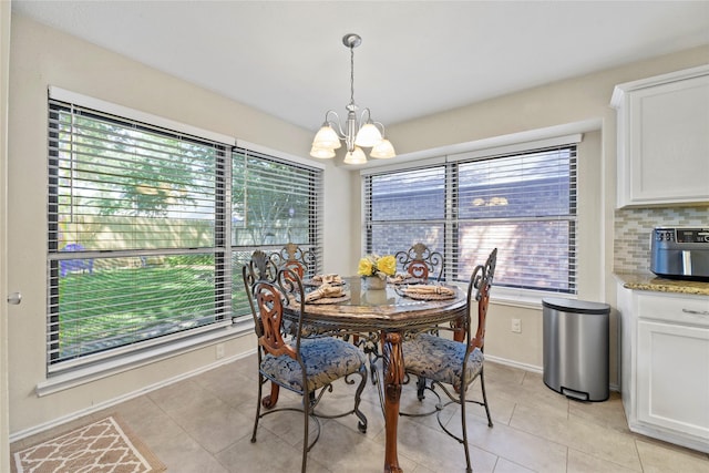 16310 Leamington Ln, Houston, TX 77095 - dining space featuring a chandelier, light tile patterned floors, and baseboards