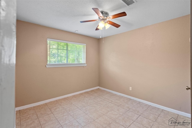 719 Kilpatrick St, Channelview, TX 77530 - spare room with a ceiling fan, a textured ceiling, and baseboards