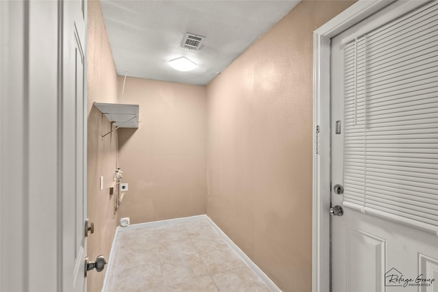 719 Kilpatrick St, Channelview, TX 77530 - washroom featuring electric dryer hookup, tile patterned floors, and baseboards