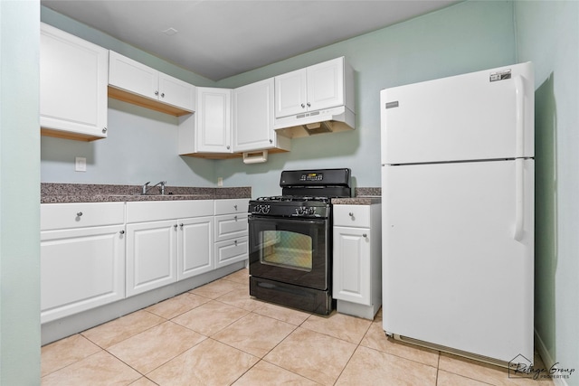 719 Kilpatrick St, Channelview, TX 77530 - kitchen with freestanding refrigerator, black range with gas cooktop, under cabinet range hood, a sink, and white cabinets