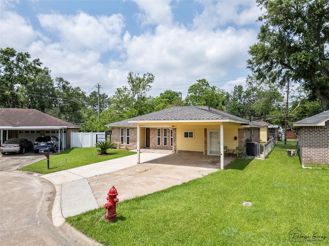719 Kilpatrick St, Channelview, TX 77530 - rear view of property featuring concrete driveway, an attached carport, and brick siding