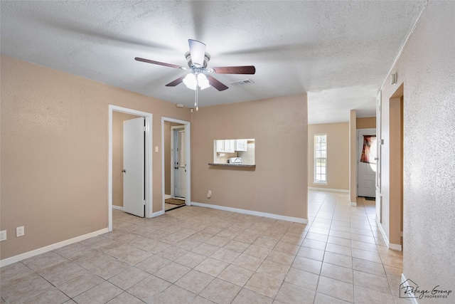 719 Kilpatrick St, Channelview, TX 77530 - empty room with a ceiling fan, light tile patterned floors, and a textured ceiling