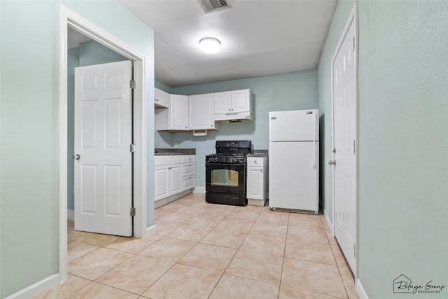 719 Kilpatrick St, Channelview, TX 77530 - kitchen with freestanding refrigerator, black range with gas stovetop, under cabinet range hood, white cabinets, and light tile patterned floors