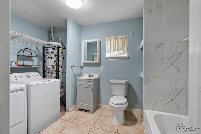 719 Kilpatrick St, Channelview, TX 77530 - bathroom featuring separate washer and dryer, vanity, tile patterned floors, a bathtub, and toilet