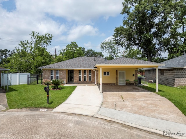 719 Kilpatrick St, Channelview, TX 77530 - view of front facade with concrete driveway, brick siding, an attached carport, and a gate