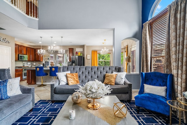25993 Royal Emerald Ln, Kingwood, TX 77339 - living room featuring a chandelier, a high ceiling, and light tile patterned floors
