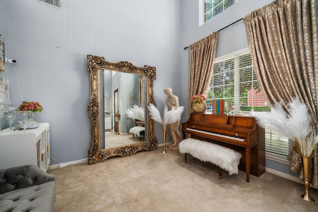 25993 Royal Emerald Ln, Kingwood, TX 77339 - living area with healthy amount of natural light, carpet, a high ceiling, and baseboards