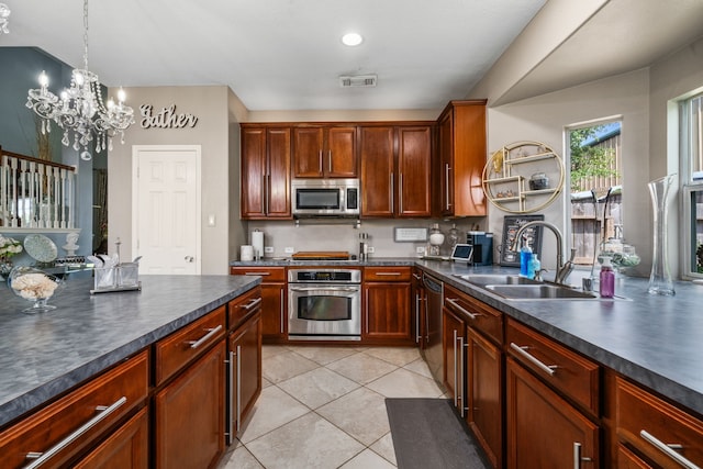 25993 Royal Emerald Ln, Kingwood, TX 77339 - kitchen featuring appliances with stainless steel finishes, a sink, dark countertops, and a chandelier