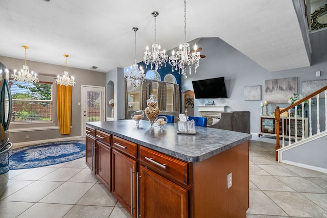 25993 Royal Emerald Ln, Kingwood, TX 77339 - kitchen with a chandelier, dark countertops, light tile patterned floors, baseboards, and lofted ceiling