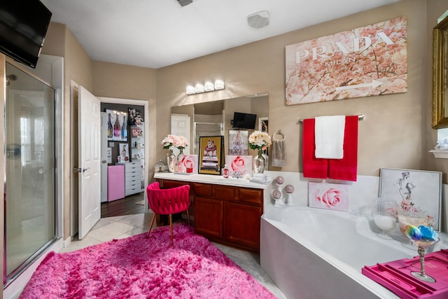 25993 Royal Emerald Ln, Kingwood, TX 77339 - full bathroom with vanity, a stall shower, a bath, and tile patterned floors