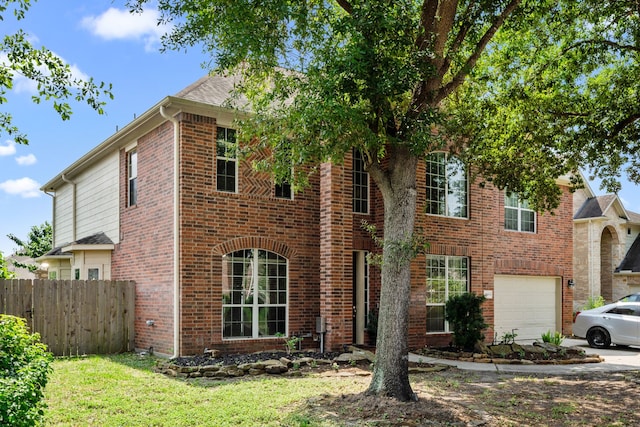 25993 Royal Emerald Ln, Kingwood, TX 77339 - view of front of home with an attached garage, brick siding, and driveway