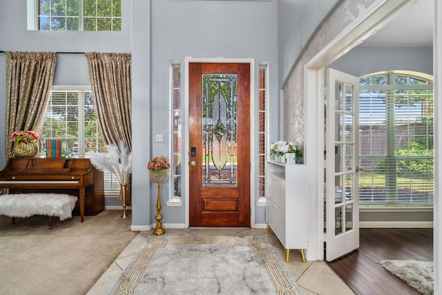 25993 Royal Emerald Ln, Kingwood, TX 77339 - tiled foyer with baseboards and a towering ceiling