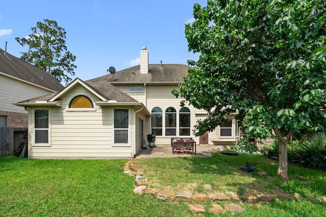 25993 Royal Emerald Ln, Kingwood, TX 77339 - back of property featuring a patio, a chimney, and a shingled roof