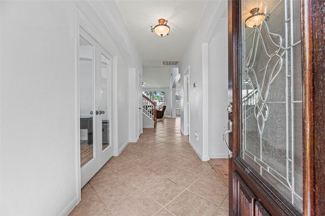 10307 Antelope Aly, Missouri City, TX 77459 - foyer with french doors, light tile patterned floors, baseboards, and stairway
