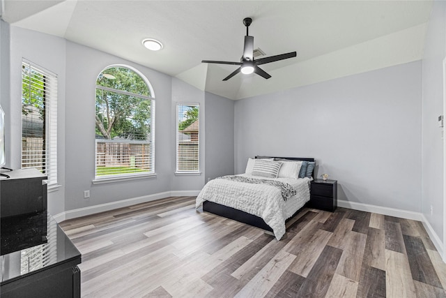 10307 Antelope Aly, Missouri City, TX 77459 - bedroom with wood finished floors, baseboards, lofted ceiling, and ceiling fan