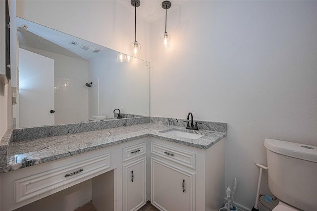 full bath with toilet, vanity, and a shower