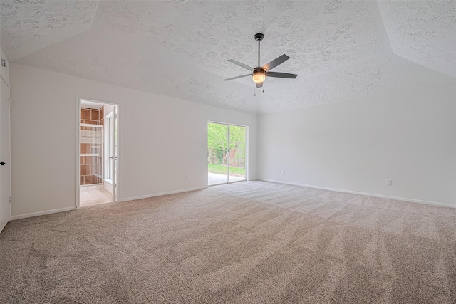 unfurnished room with a textured ceiling, light carpet, a ceiling fan, baseboards, and lofted ceiling