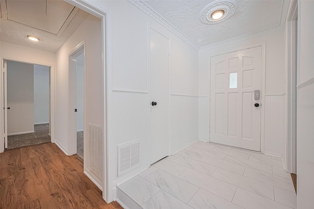 foyer entrance with a textured ceiling