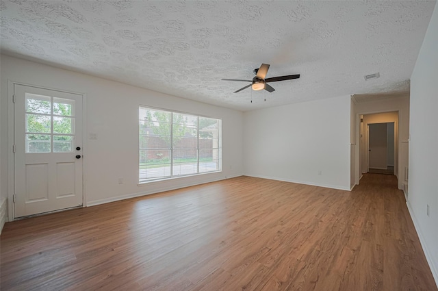 unfurnished living room with light wood-type flooring, healthy amount of natural light, a textured ceiling, and ceiling fan