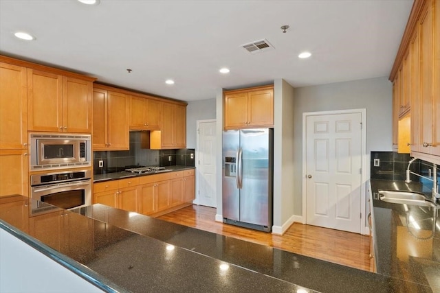 2520 Robinhood St Unit 1205, Houston, TX 77005 - kitchen with stainless steel appliances, a sink, decorative backsplash, recessed lighting, and baseboards
